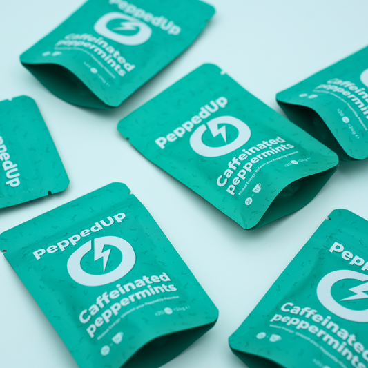 Neatly staggered rows of PeppedUp peppermint pouches with lightning logo visible