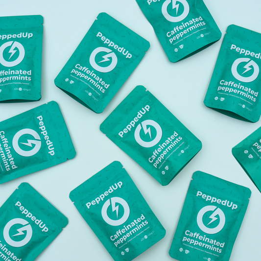 Multiple teal PeppedUp pouches arranged randomly on flat pastel background